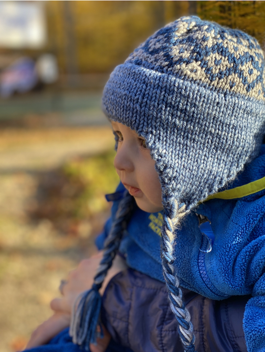 Knitted child's hat with cheap ear flaps