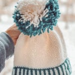 blue and aqua hat with pompom