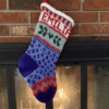 handknit christmas stocking hung by fire